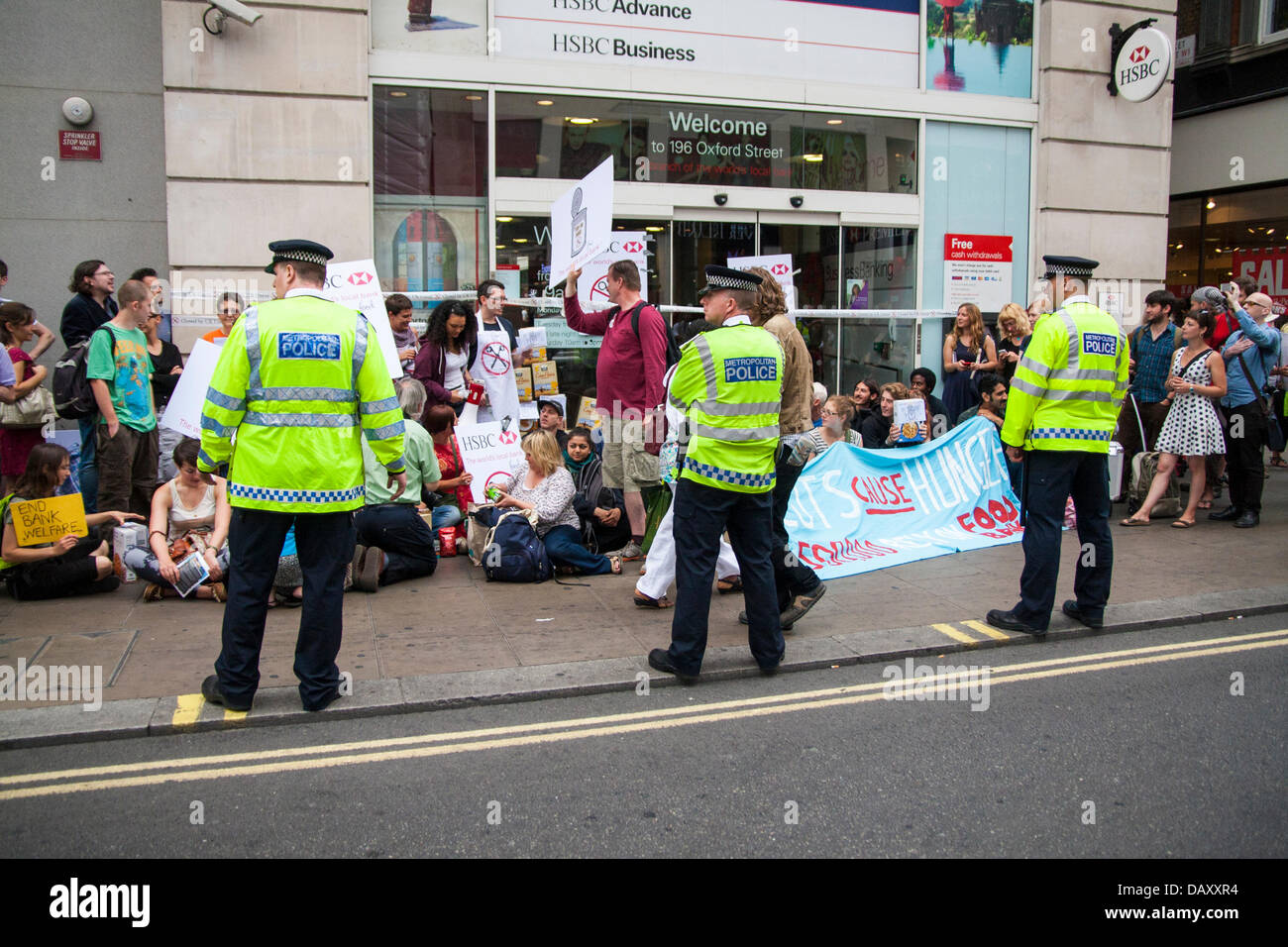 London, UK. 20th July, 2013. Police keep watch as UK Uncut hold demonstrations outside two London branches of HSBC in protest against what they say is tax dodging by the bank, as welfare cuts drive more people to reliance on foodbanks. Credit:  Paul Davey/Alamy Live News Stock Photo