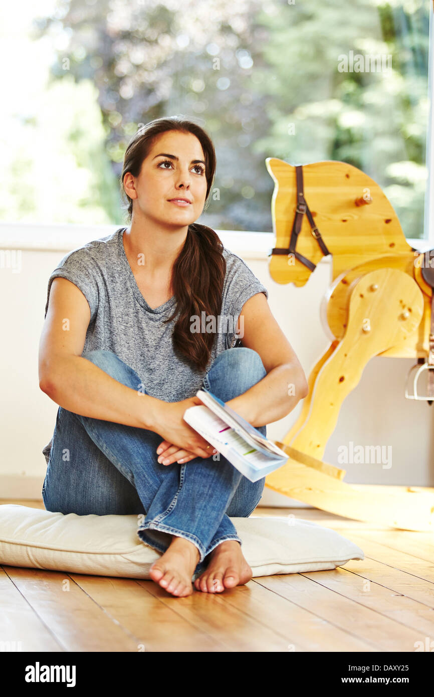 Woman reading book at home Stock Photo