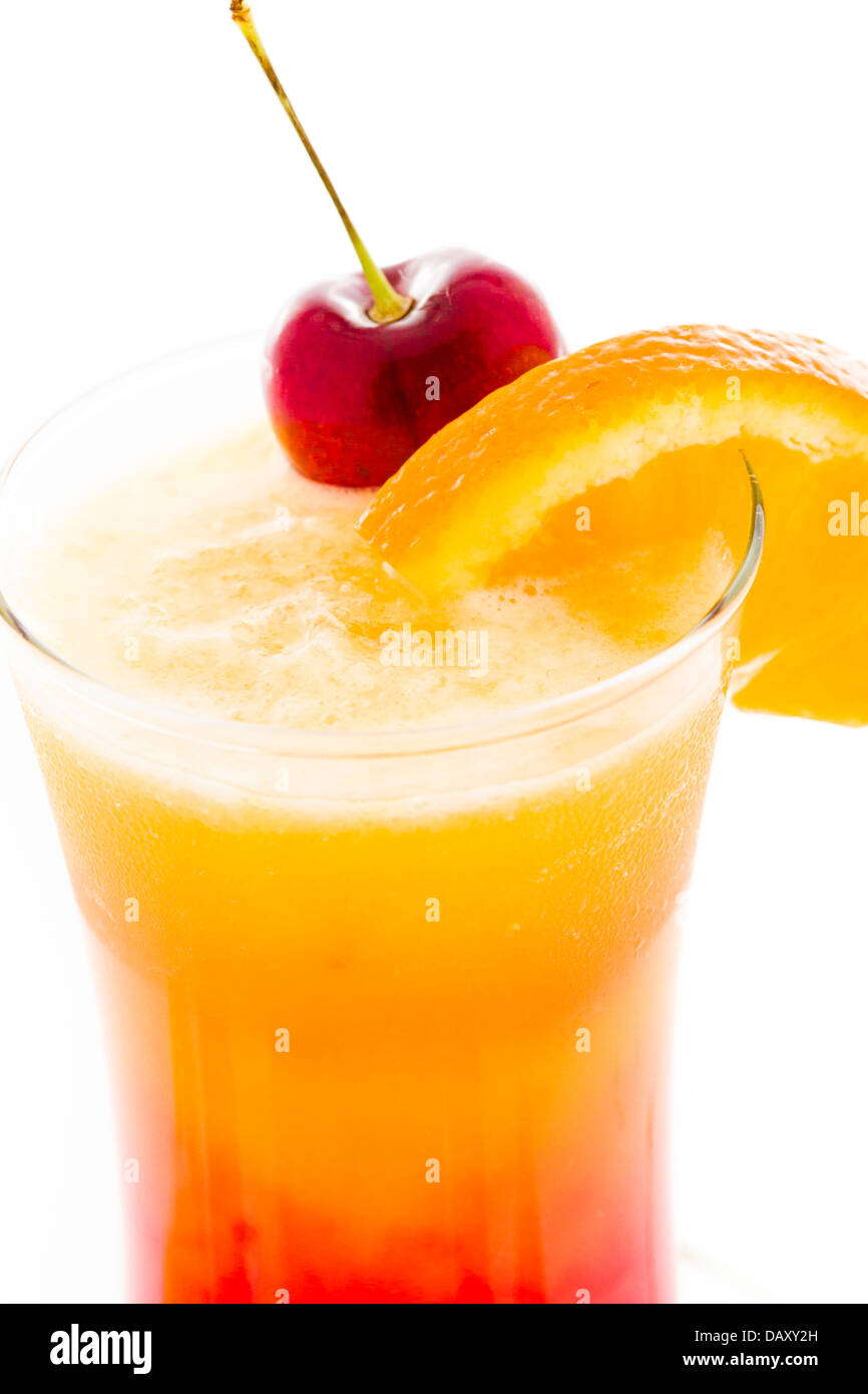 Tequila sunrise cocktail with orange wedge and cherry as a garnish