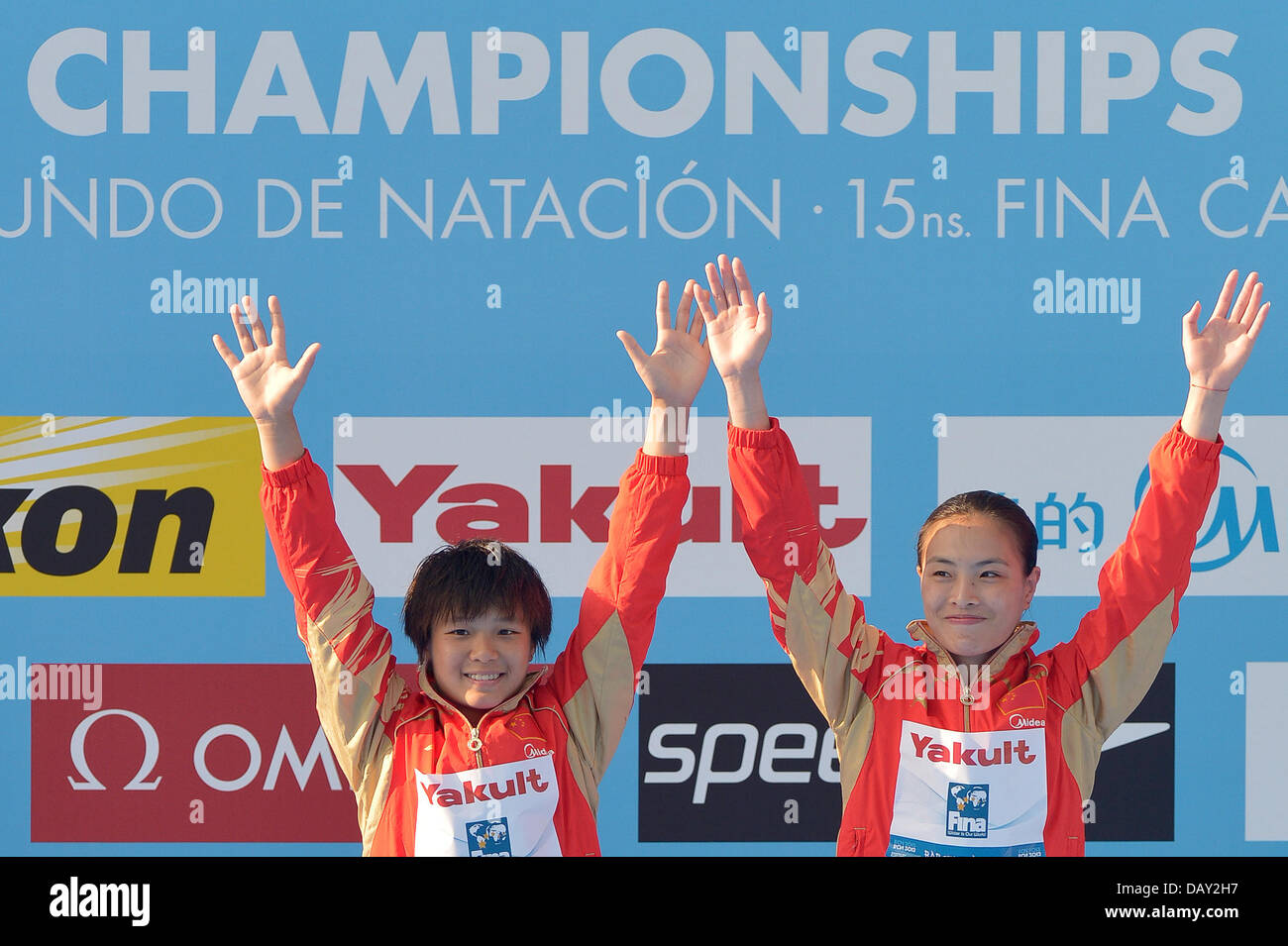 Barcelona, Spain. 20th July, 2013. Gold medalists Minxa Wu and Tingmao Shi of China celebrates on the podium after the women's 3m Synchro Springboard diving final of the 15th FINA Swimming World Championships at Montjuic Municipal Pool in Barcelona, Spain, 20 July 2013. Foto: David Ebener/dpa /dpa/Alamy Live News Stock Photo