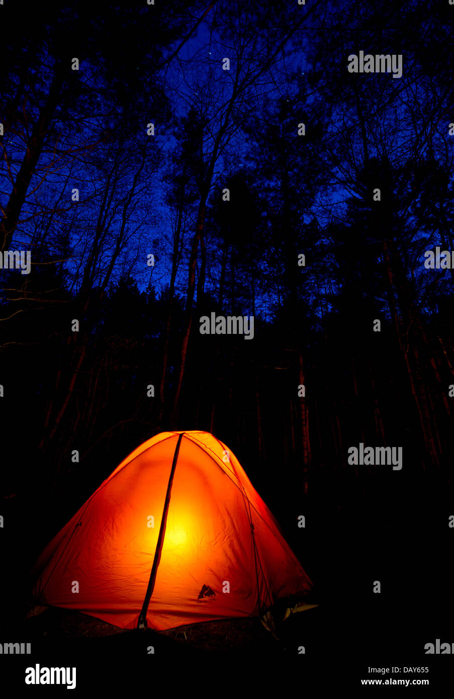 A glowing tent under the night sky Stock Photo