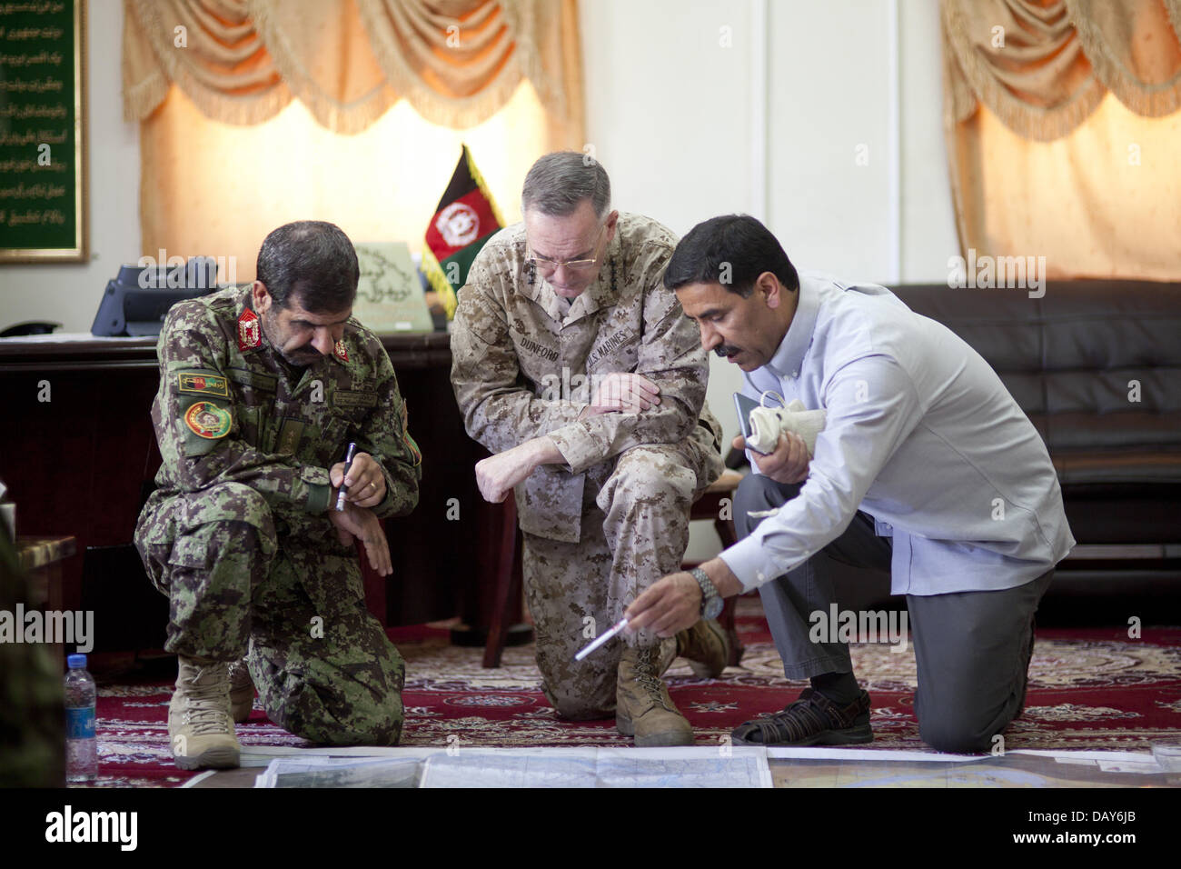 US Marine Corps General Joseph Dunford, commander of the International Security Assistance Force examines a map with Afghan National Army Maj. Gen. Sayed Malook, left, commanding general of the 215th Corps, during a visit May 27, 2013 to Camp Shorabak, Helmand province, Afghanistan. Stock Photo