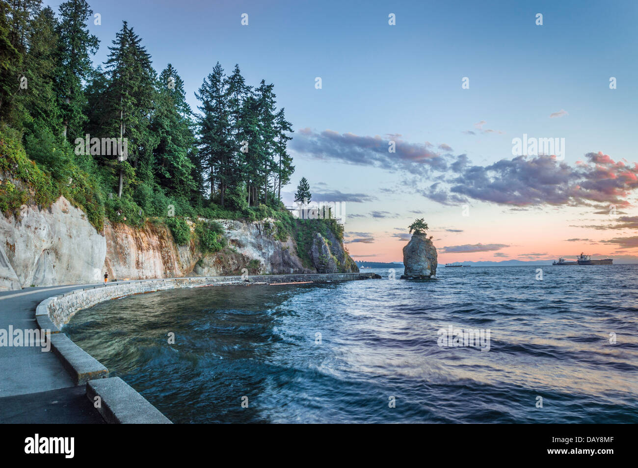 Looking South on a summer evening along the Stanley Park seawall at Siwash Rock, Vancouver, BC, Canada. Stock Photo
