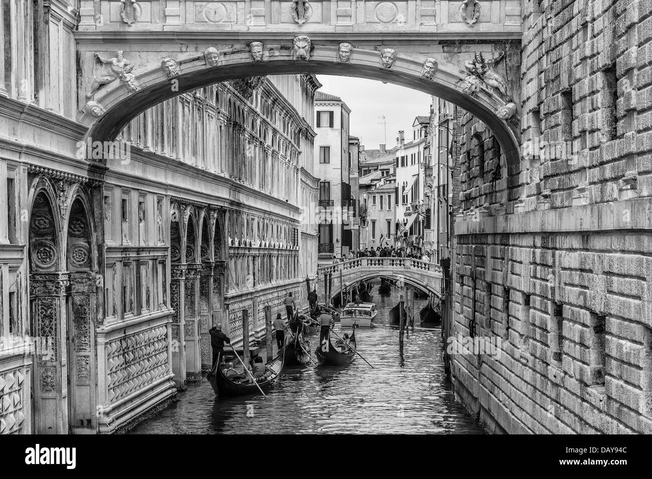 Black and White Image of Gondolas Passing under the Bridge of Sighs in Venice, Italy Stock Photo