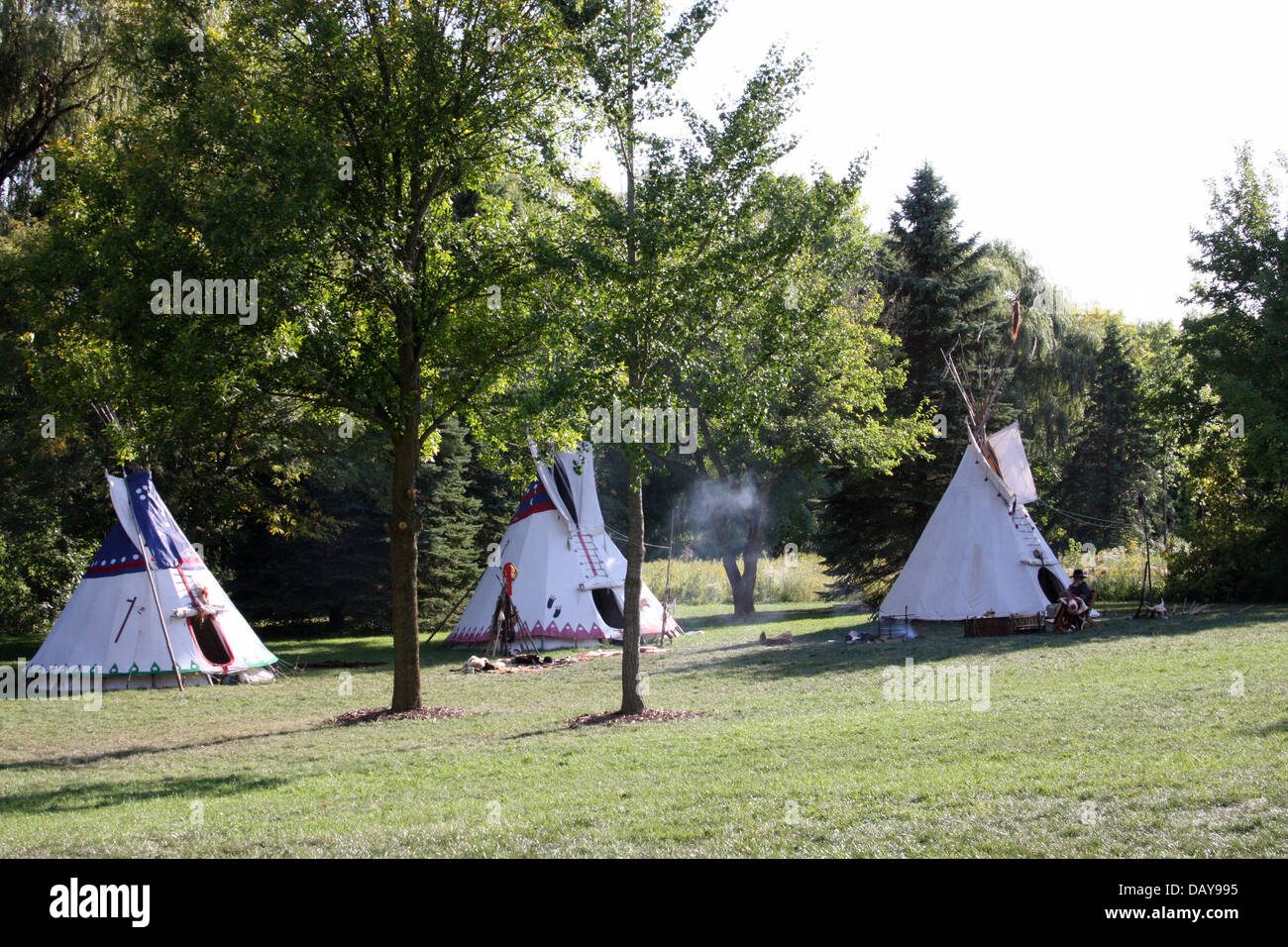 Native American Indian campsite with three tipis Stock Photo