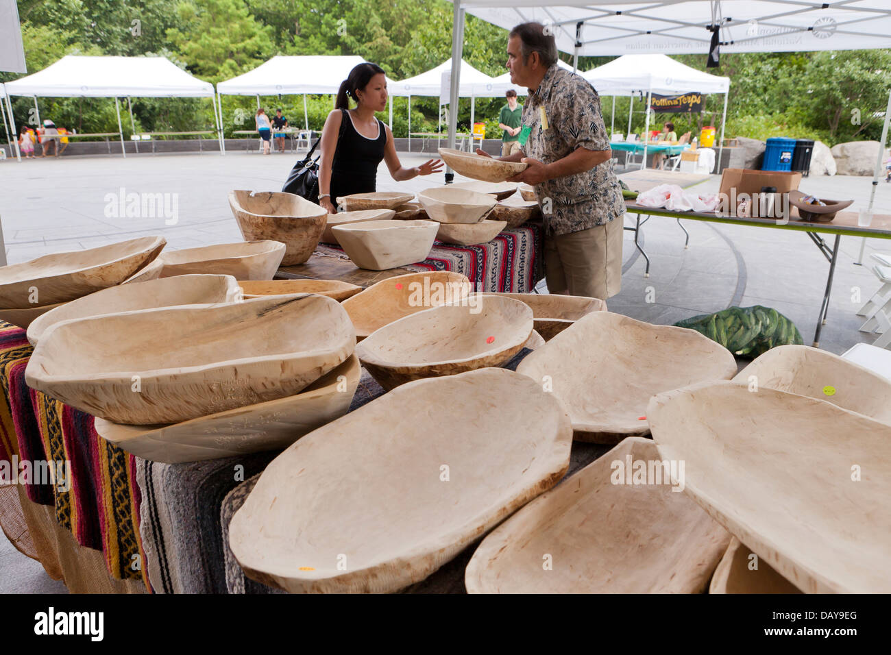 Man selling hand carved wooden bowls Stock Photo