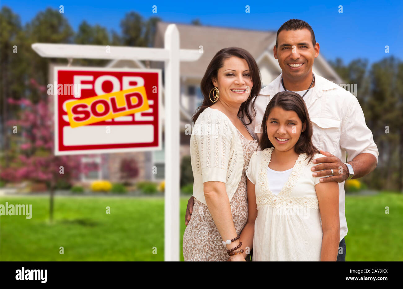 Hispanic Mother, Father and Daughter in Front of Their New Home with ...