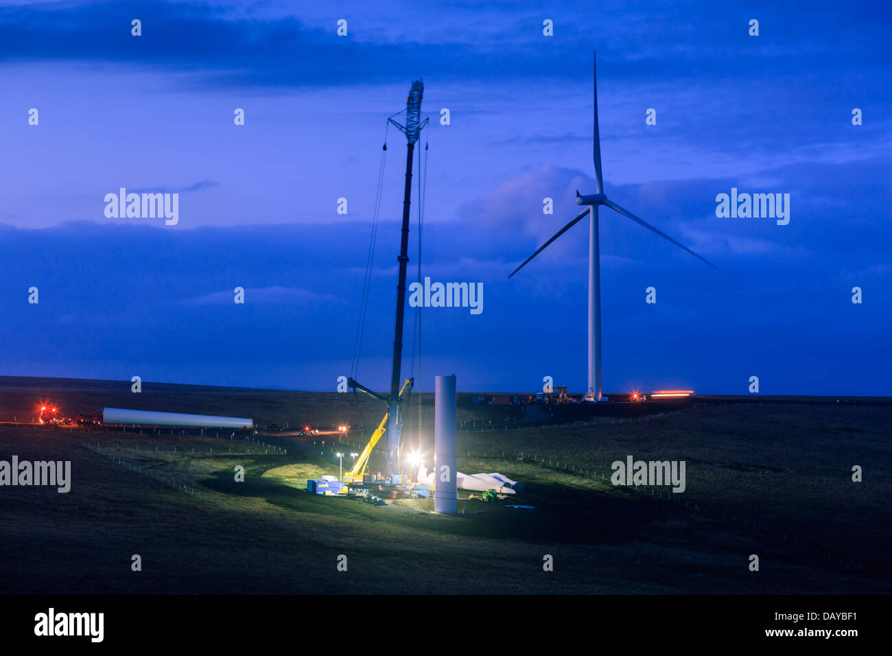 Constructing a Wind Turbine at night Stock Photo