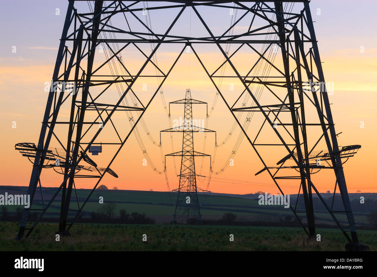 An electricity pylon of the National Grid in Wales at sunset Stock Photo