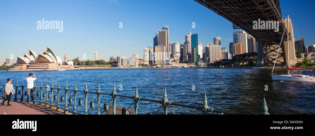View of Sydney city and Sydney Harbour with a couple of tourists looking at the view, Australia Stock Photo