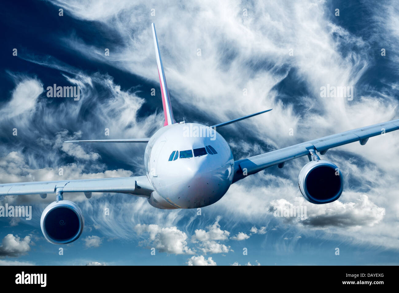 Passenger Airliner flying in the clouds Stock Photo - Alamy