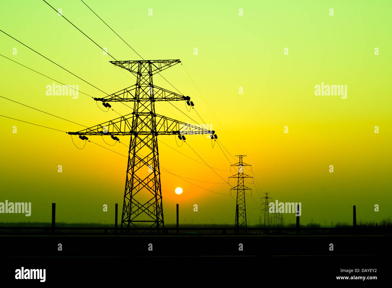 sunset under the high-voltage tower in the background Stock Photo - Alamy
