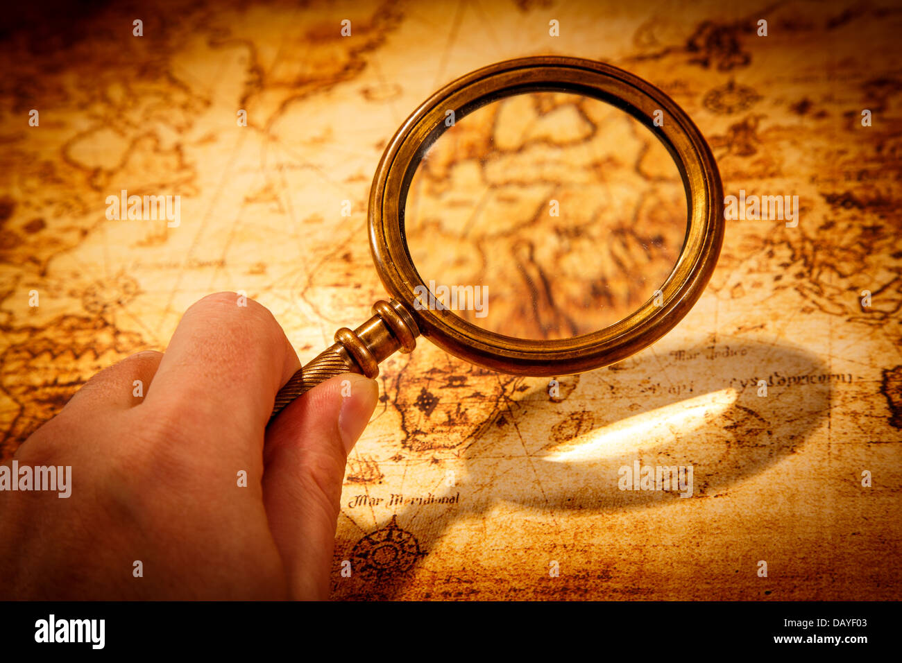 Vintage still life. Vintage magnifying glass lies on an ancient world map Stock Photo