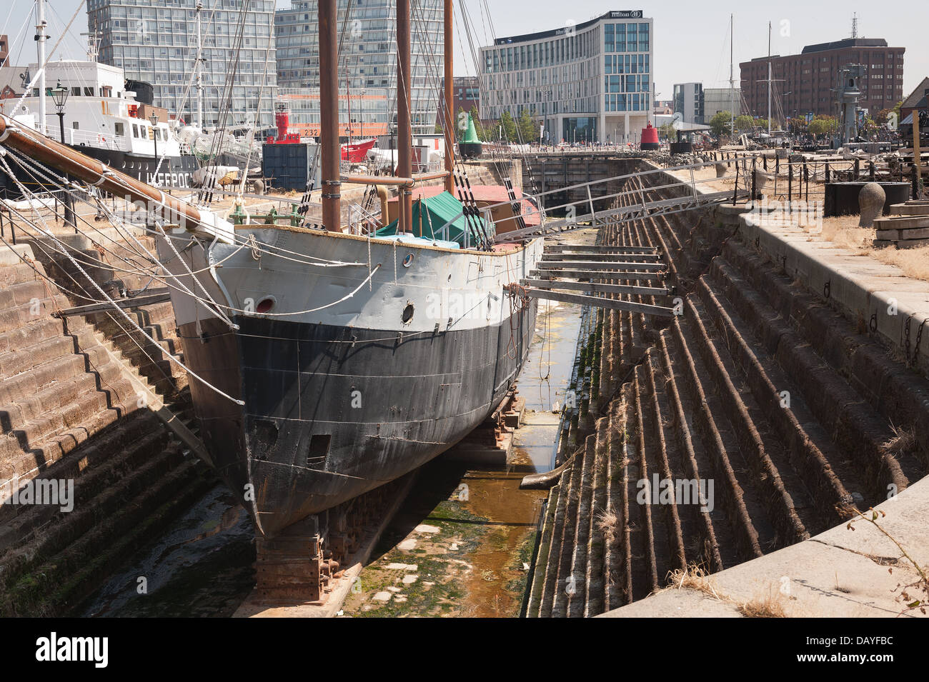 The De Wadden trading sailing ship boat in Canning dry dock against modern rebuild skyline contrasts older traditional past Stock Photo