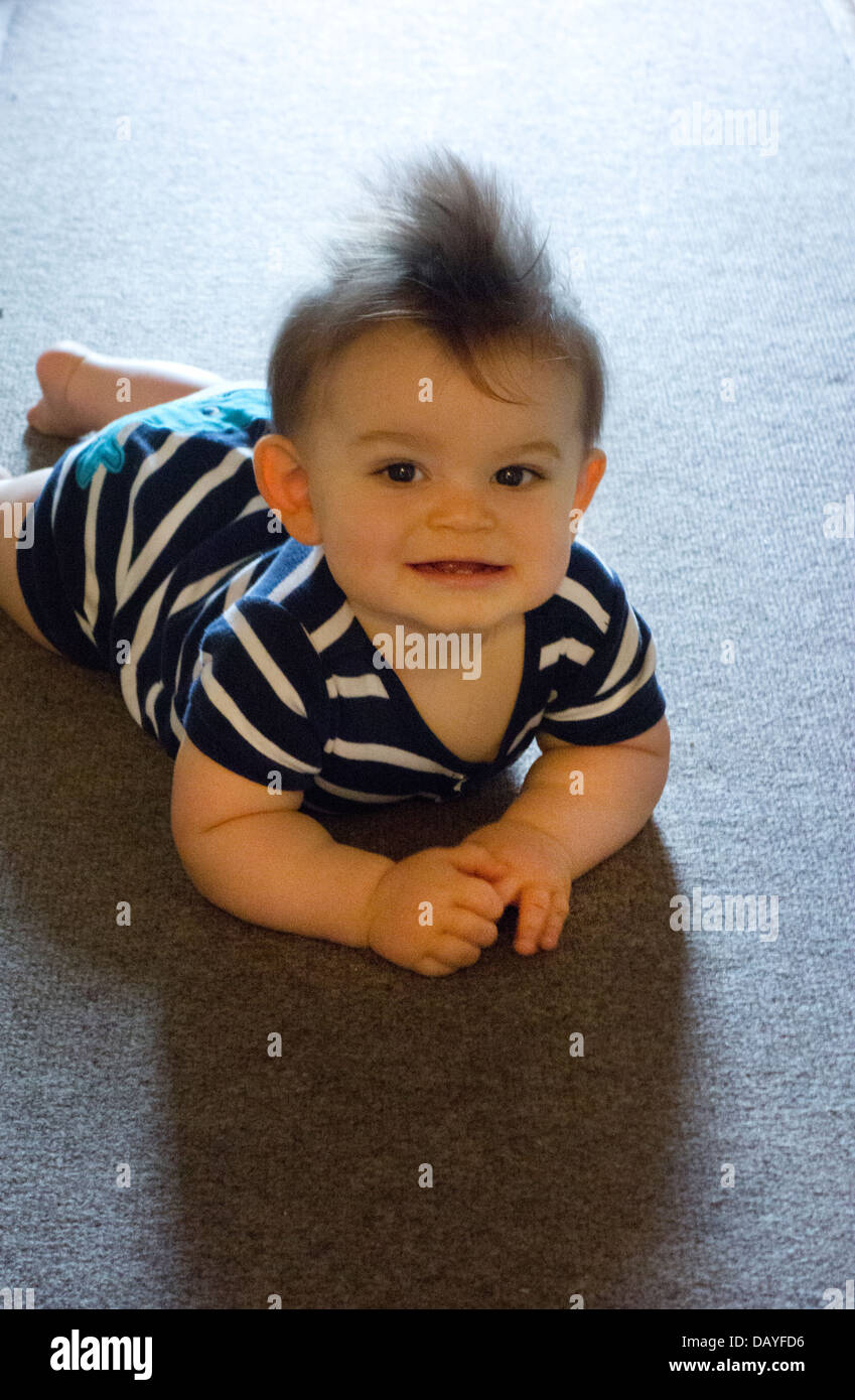 baby boy learning to crawl on rug Stock Photo Alamy