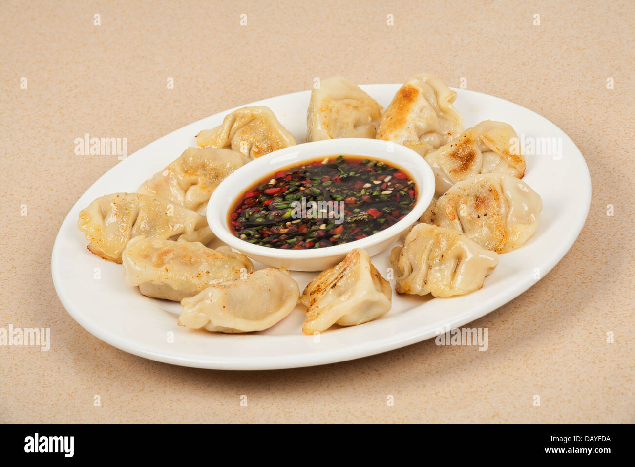 Homemade Chinese dumplings with dipping sauce. Also known as Pot Stickers. Also has a clipping path. Stock Photo