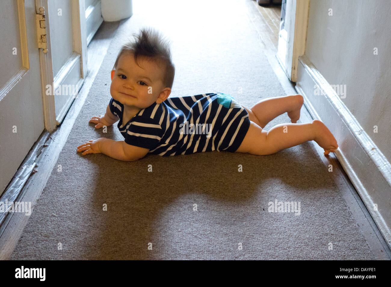 baby boy learning to crawl on rug Stock Photo Alamy