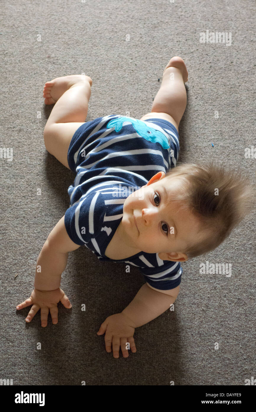 baby boy learning to crawl on rug Stock Photo Alamy