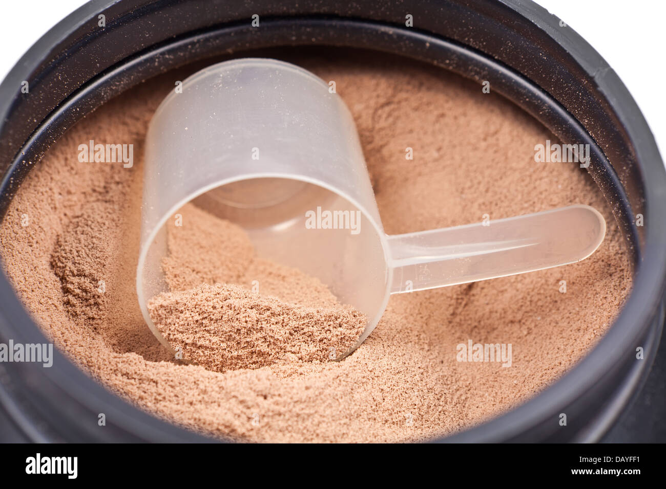 Scoop of chocolate whey isolate protein in a black plastic container on