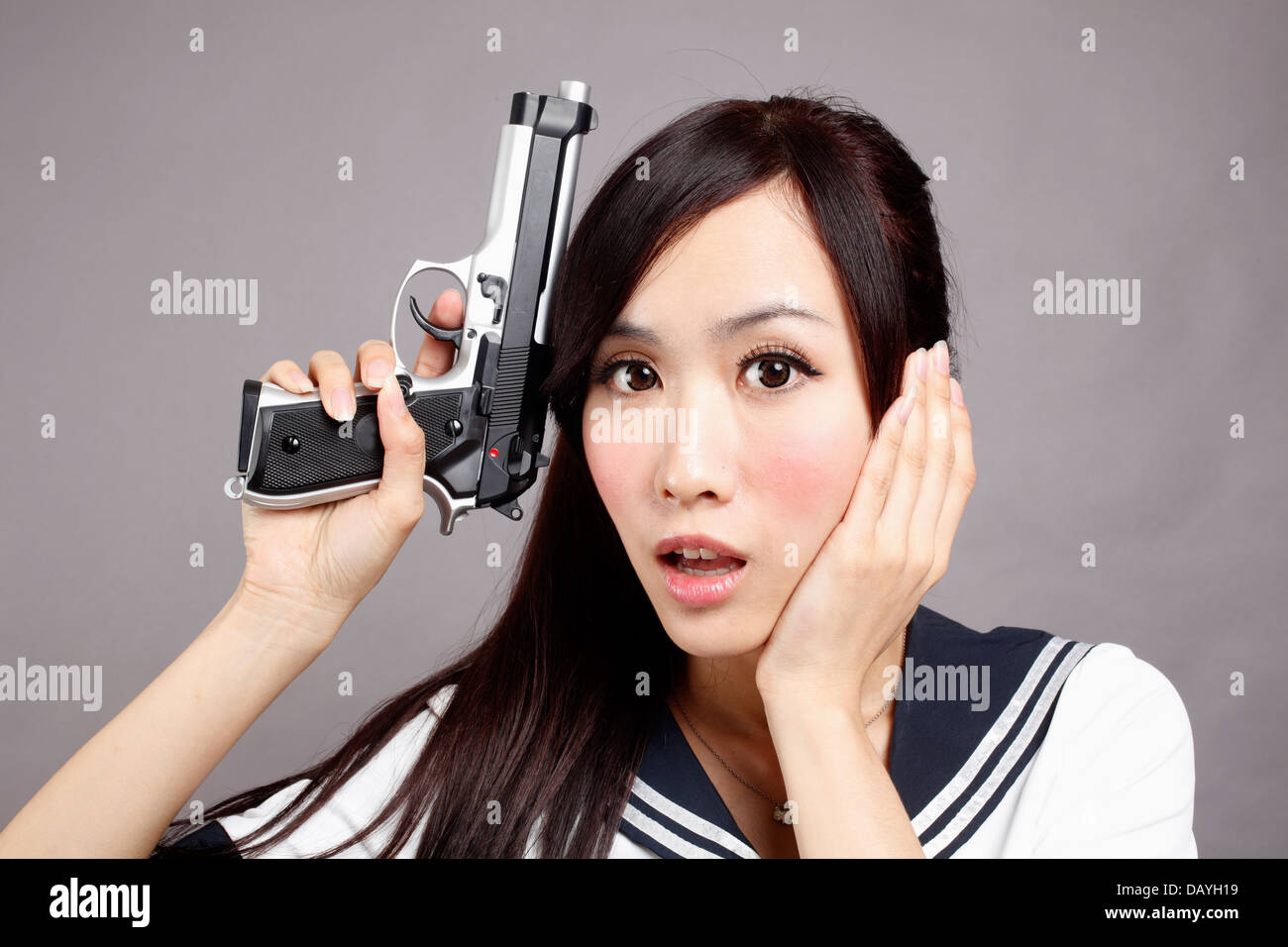 School girl plays gun. Stock Photo