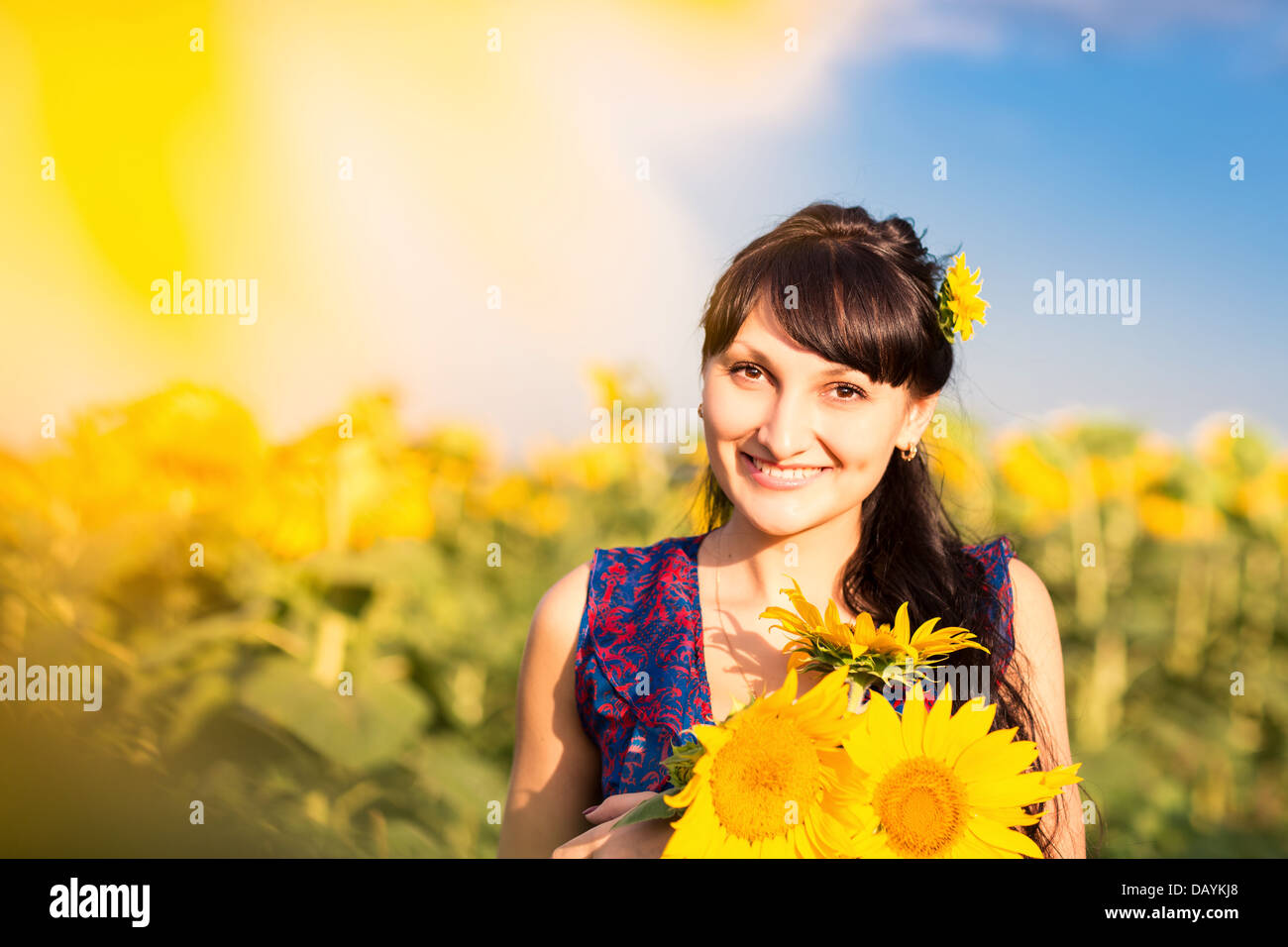 Young beautiful woman with a bouquet of sunflowers in the field Stock ...