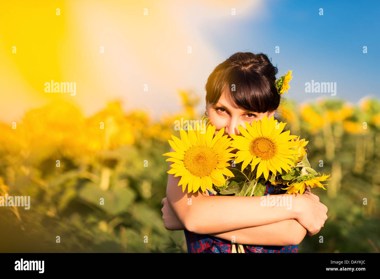 Young beautiful woman with a bouquet of sunflowers in the field Stock ...