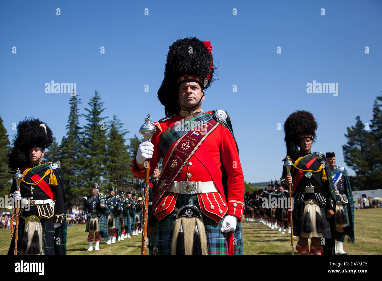 Scottish marching band at Tomintoul, UK. July, 2013. The Drum Major of Ballater Pipe band at the annual Tomintoul Highland games and gathering held on the 3rd Saturday in July, at the showground in the village.  This sporting, historical and traditional event in the previous years, has been beset with bad weather and has been cancelled on several occasions. The Cairngorms National Park is home to some of the best and most famous Highland Games in Scotland and has a long tradition and history where Clans would compete against each other in sporting events. Stock Photo