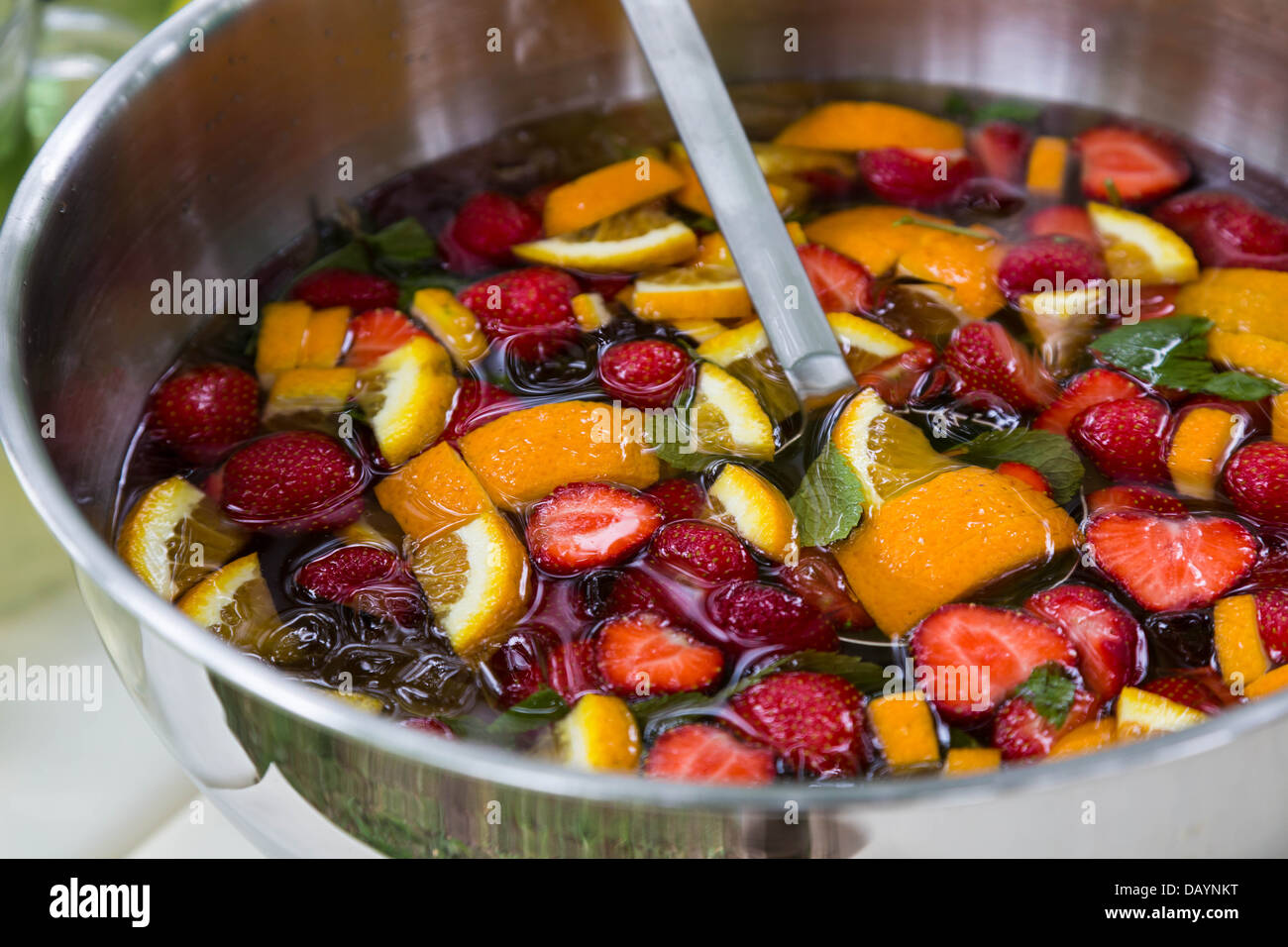 mixed punch with fresh fruits in metal bowl Stock Photo