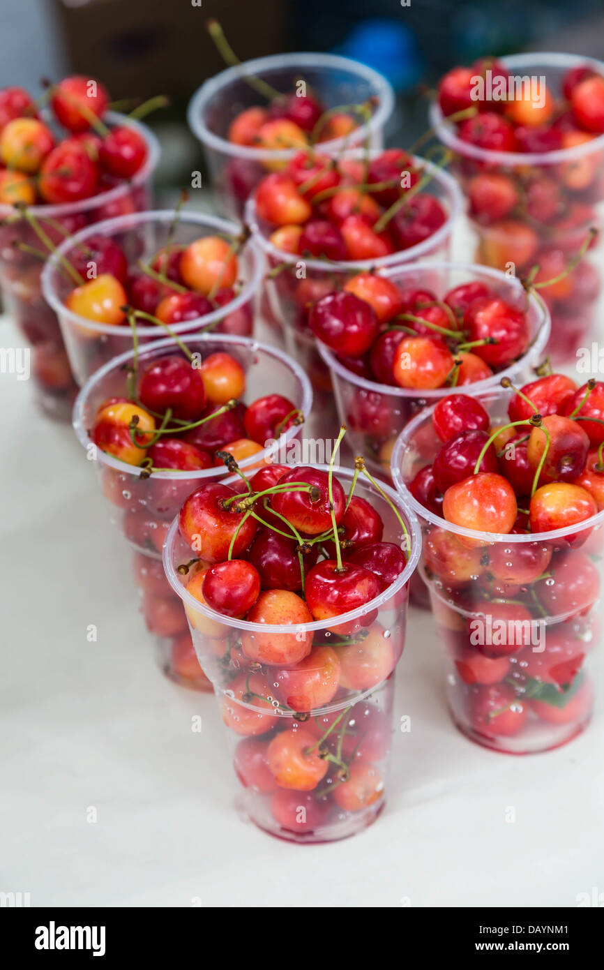 fresh white cherry in plastic glass Stock Photo