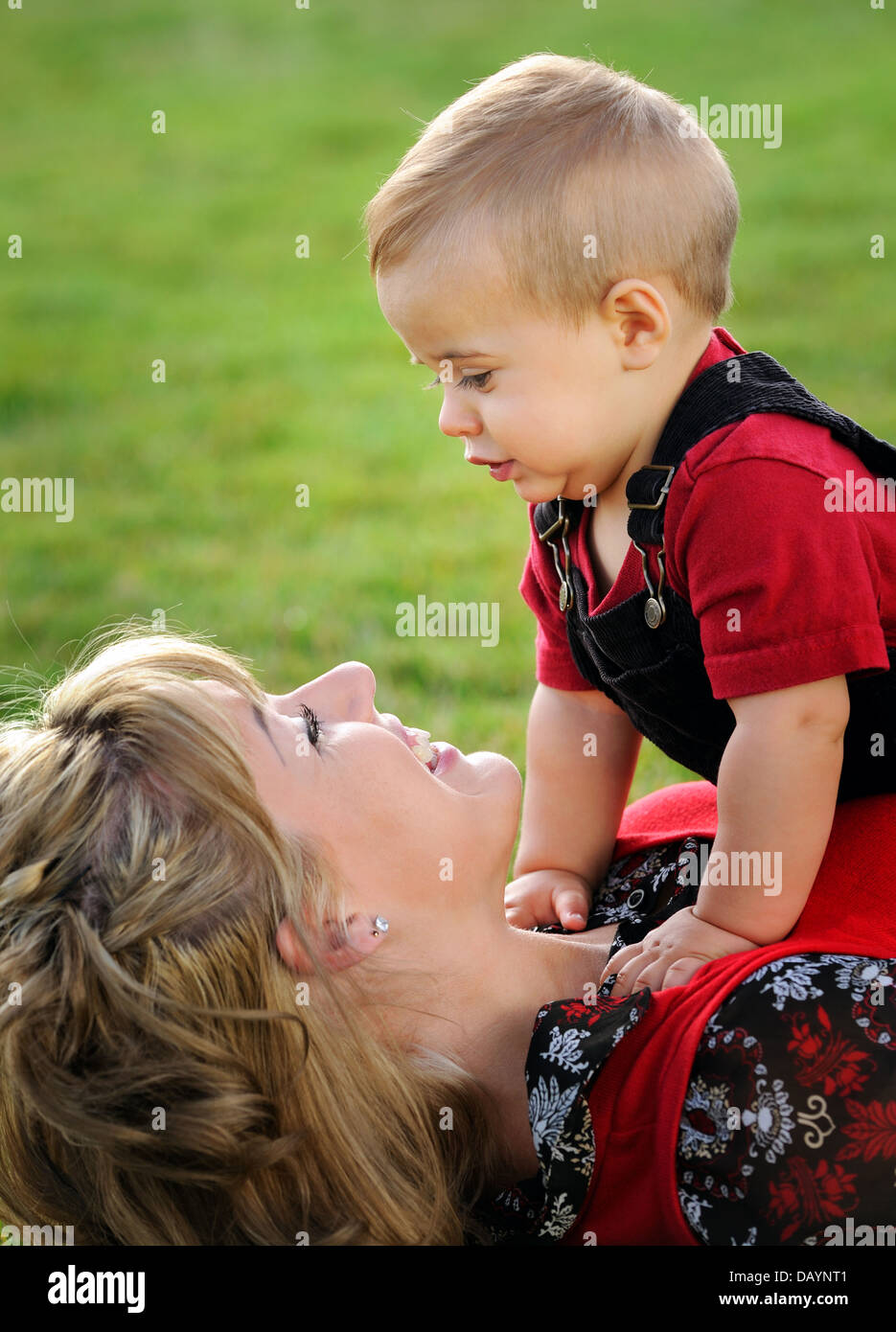 Happy young mother kissing her child Stock Photo