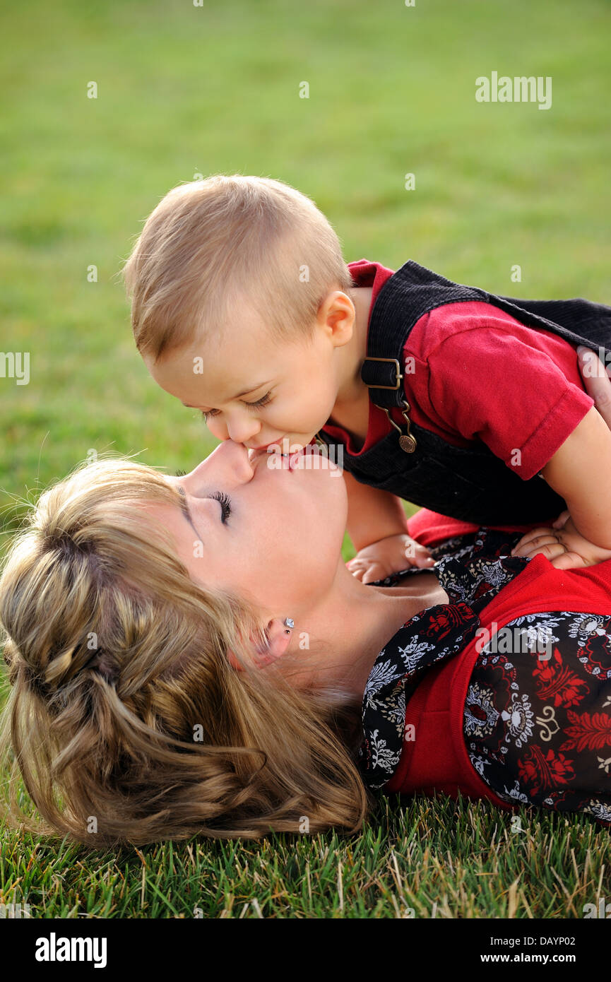 Happy young mother kissing her child Stock Photo