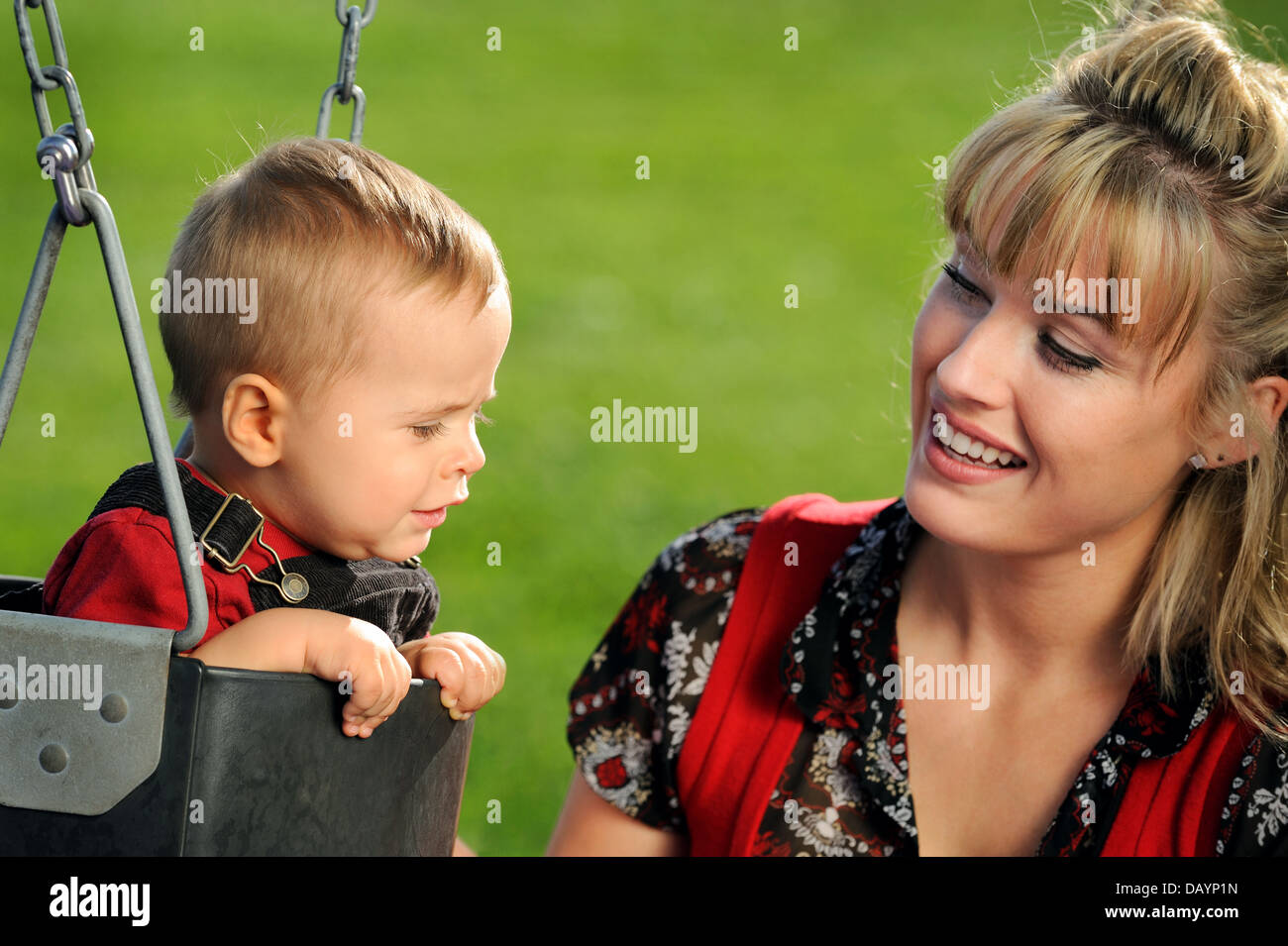 Happy young mother and child having fun at playground Stock Photo