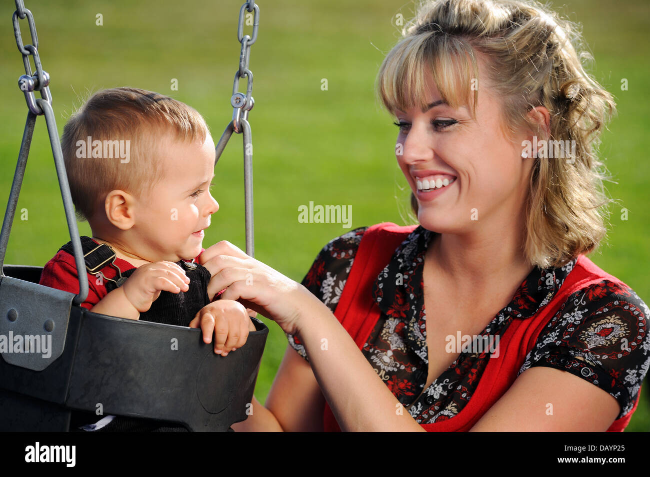 Happy young mother and child having fun at playground Stock Photo