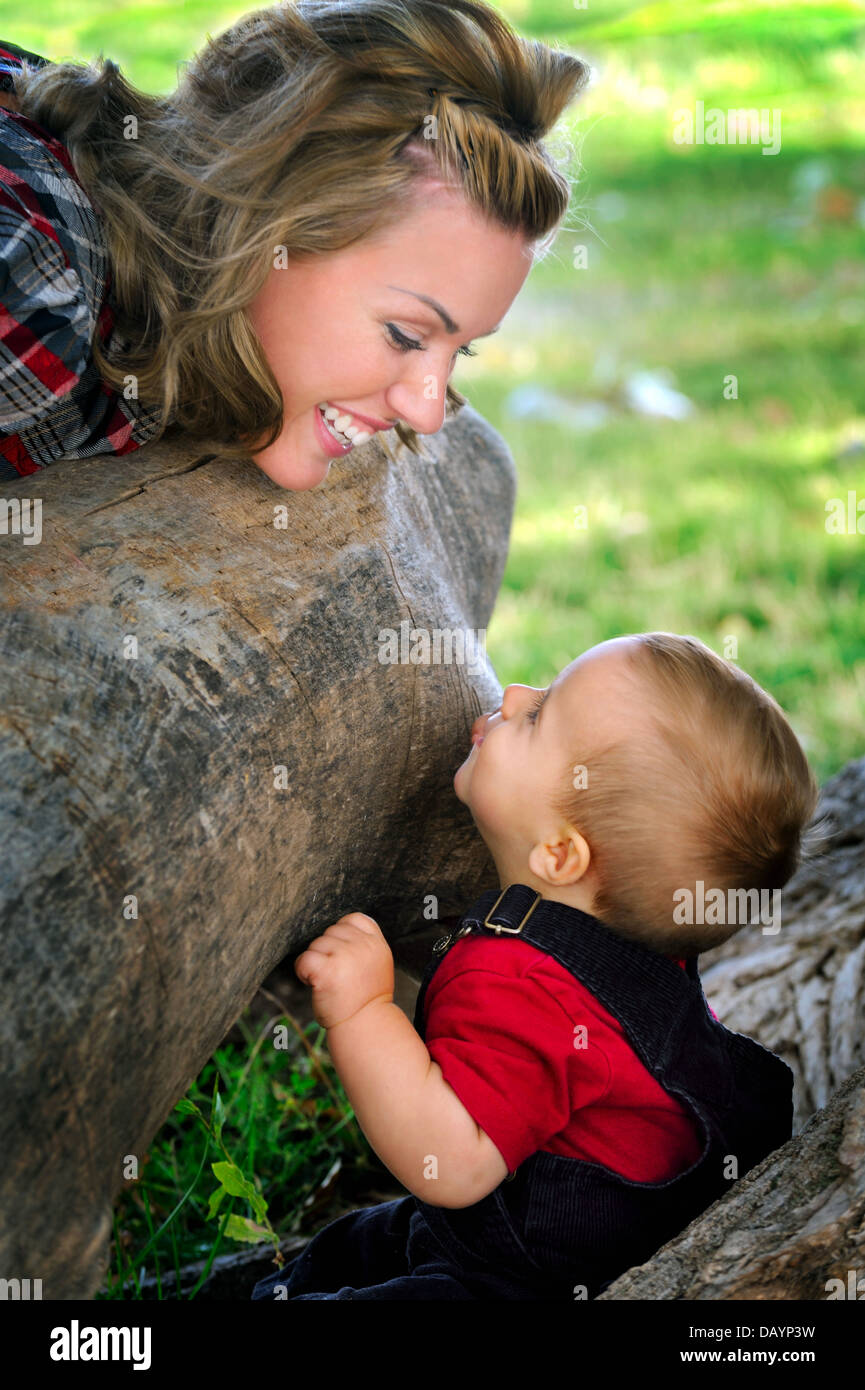 Happy young mother and child having fun in a park Stock Photo