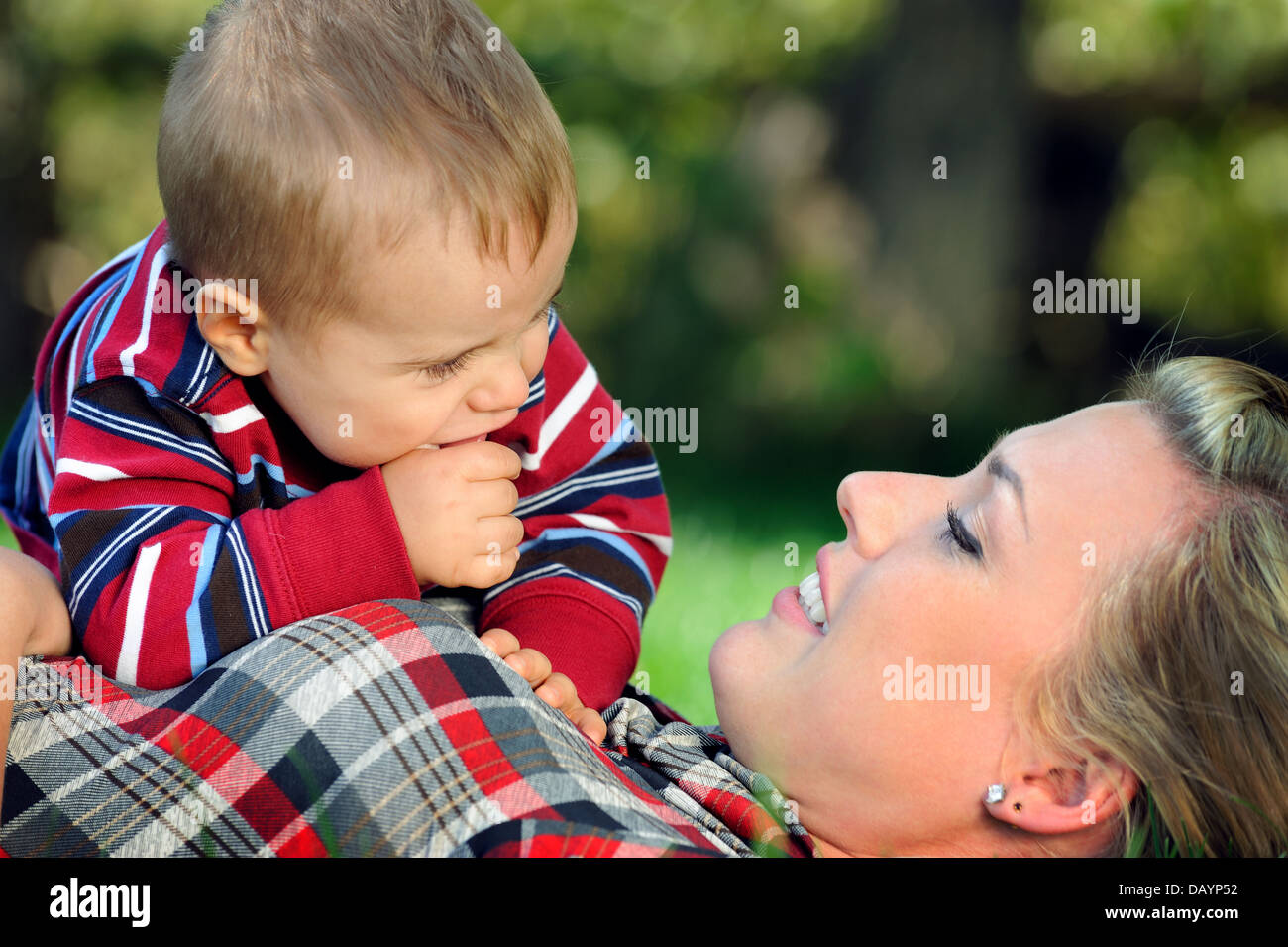 Happy young mother and child having fun in a park Stock Photo