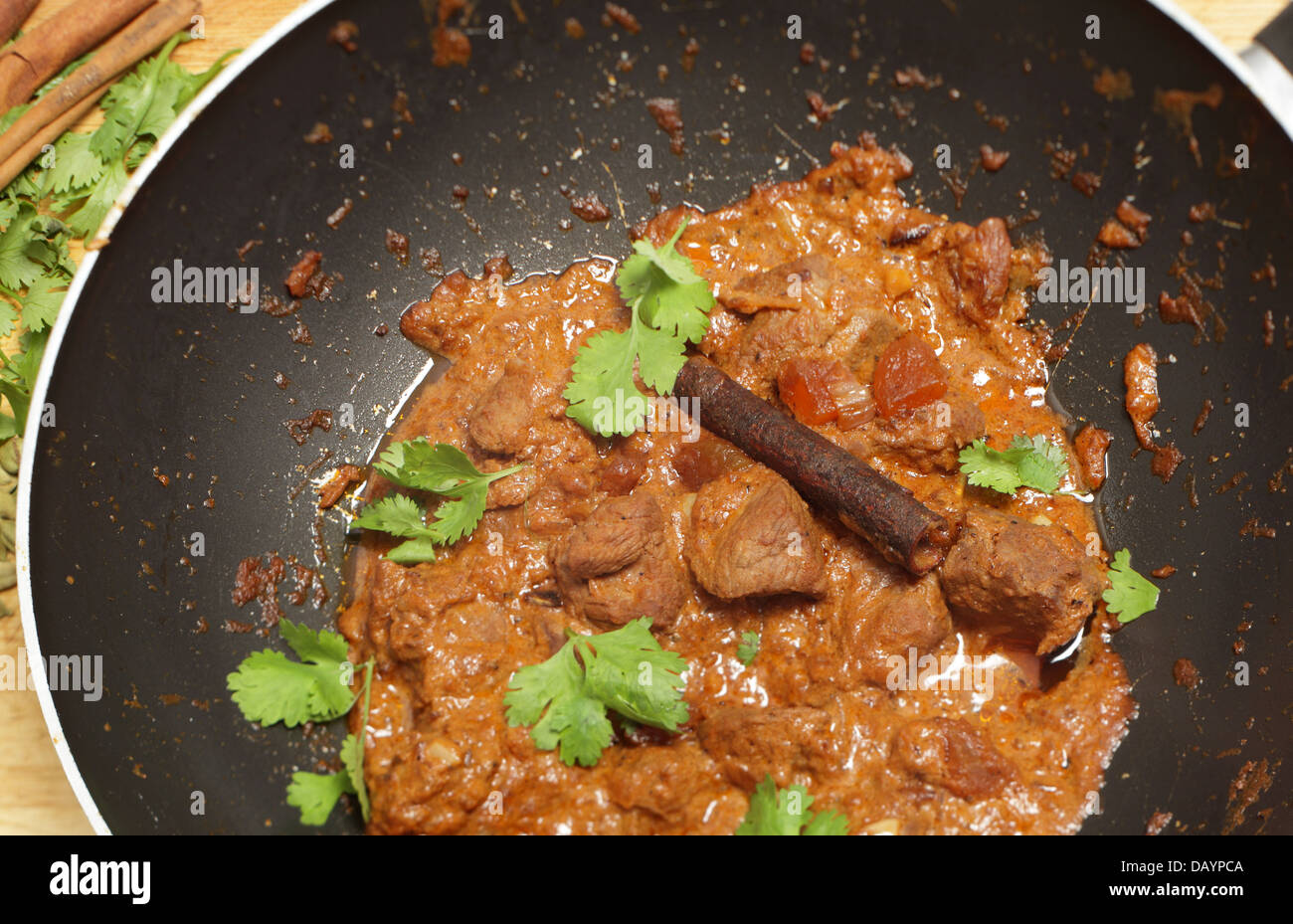 Cooking a balti lamb and yoghurt curry in a wok, high angle view Stock ...