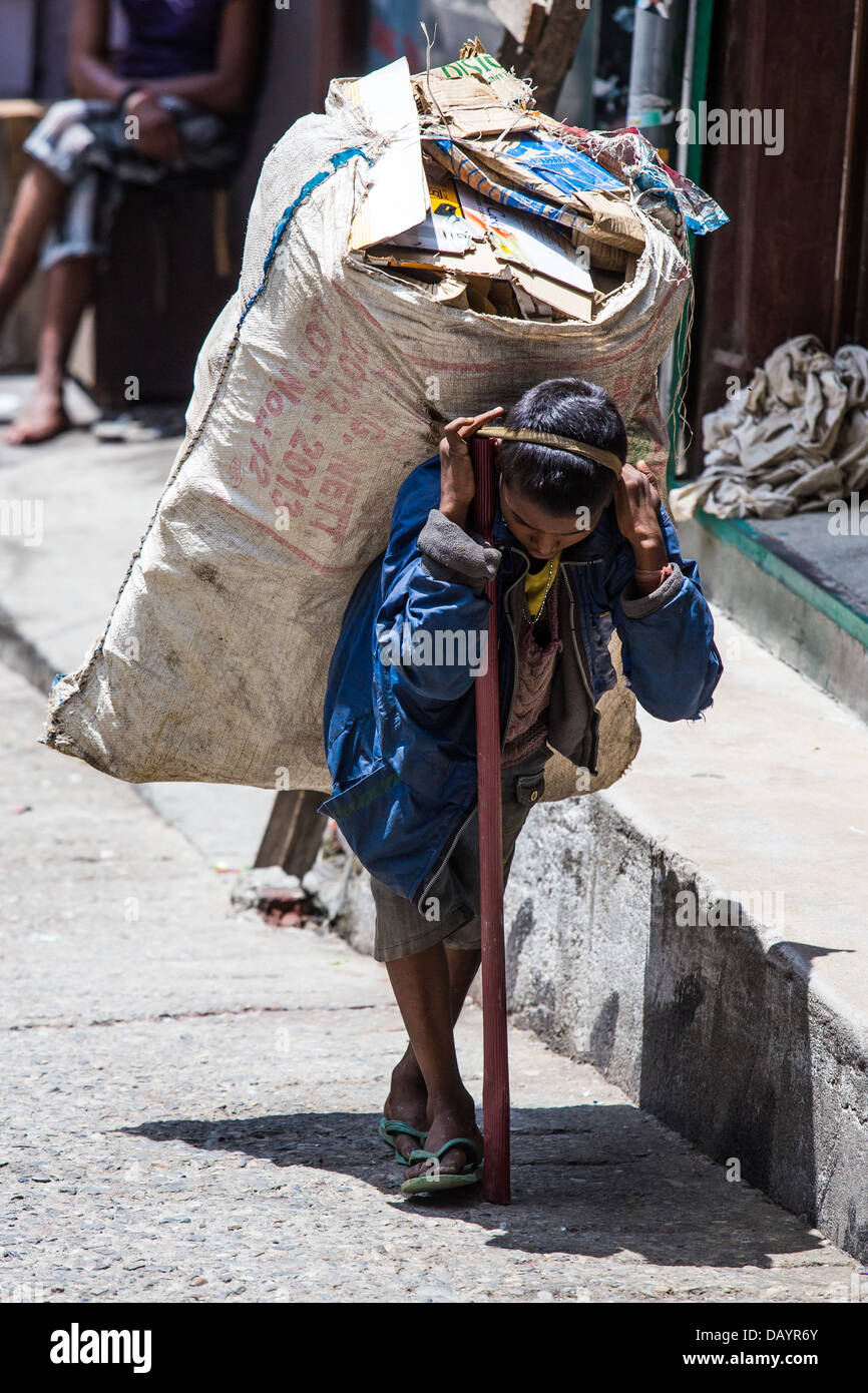 Indian boy gathering recycled material in Mussoorie, India Stock Photo