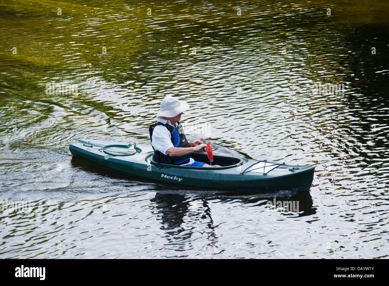Canoeist in kayak type canoe paddling down the River Wye at Glasbury