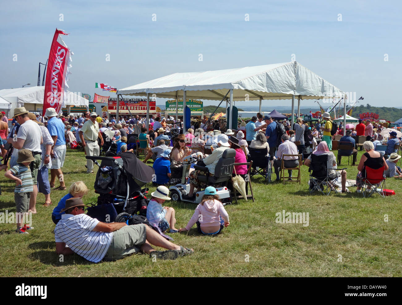 Visitors to the annual Stithians Agricultural show in Cornwall relaxing in the sunshine Stock Photo
