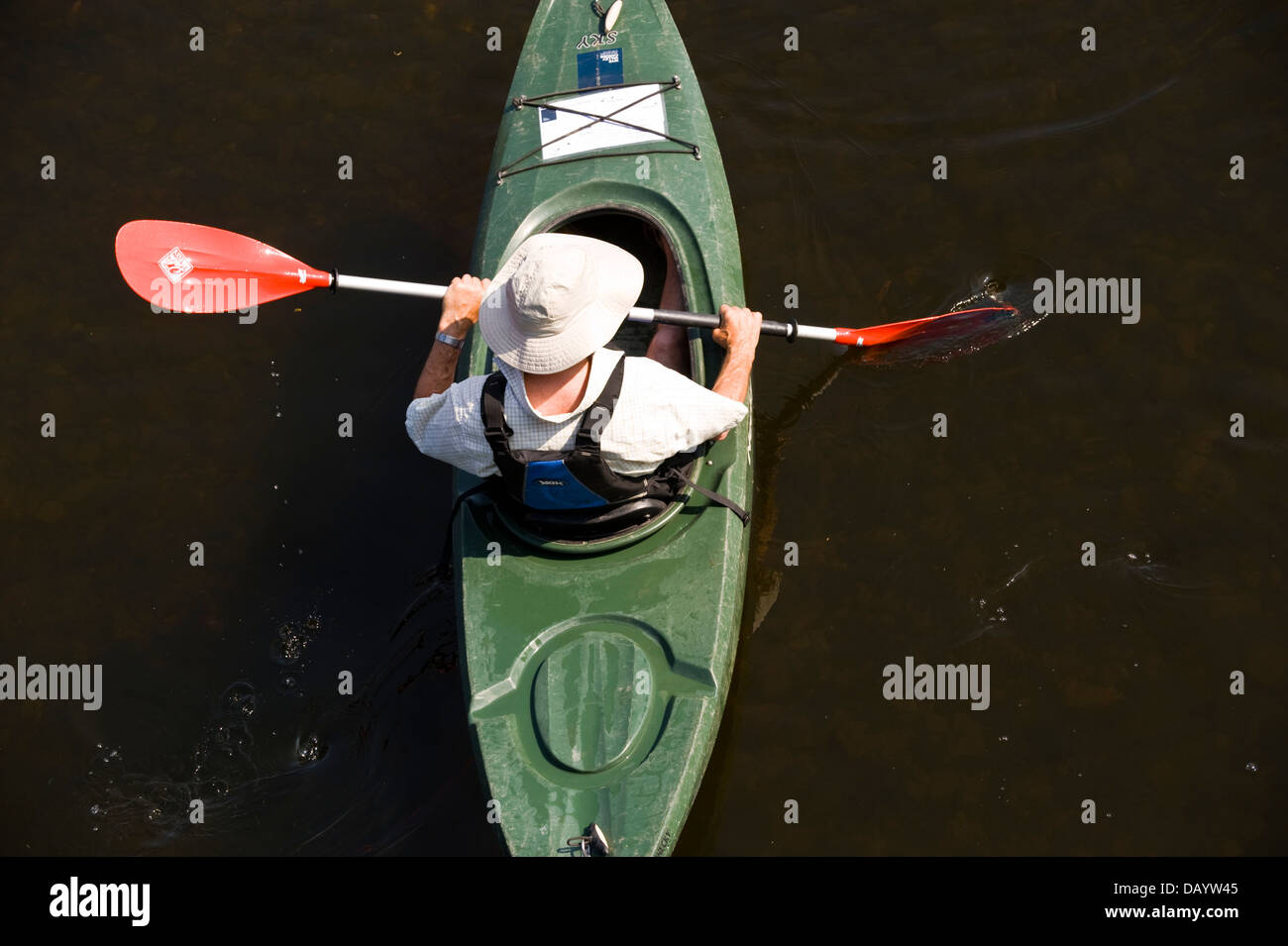 Canoeist in kayak type canoe paddling down the River Wye at Glasbury