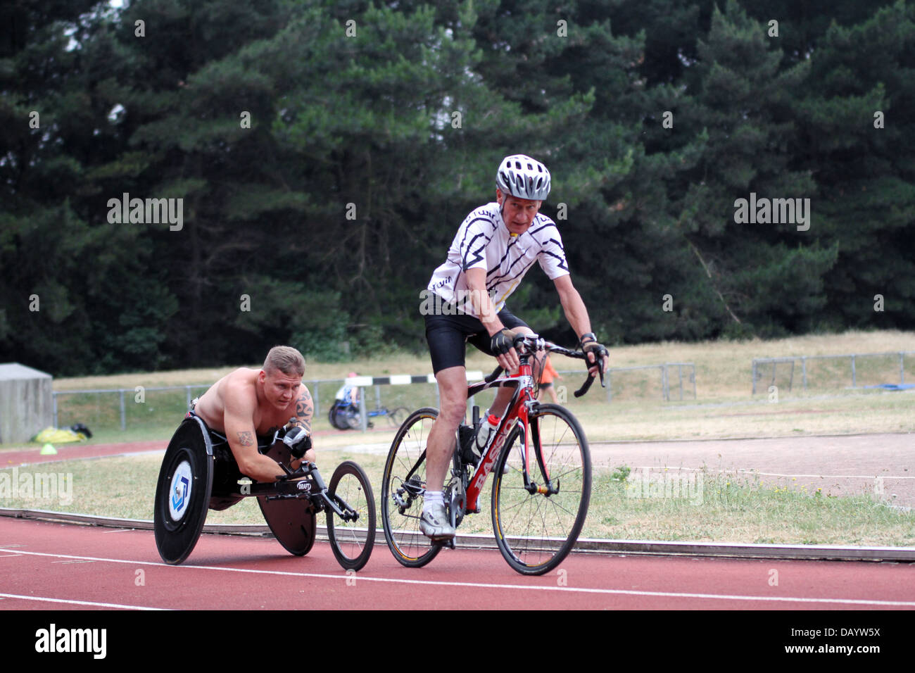 The Paralympian David Weir training at Kingsmeadow athletics track in Norbiton, South London with a cyclist as pacemaker. Stock Photo