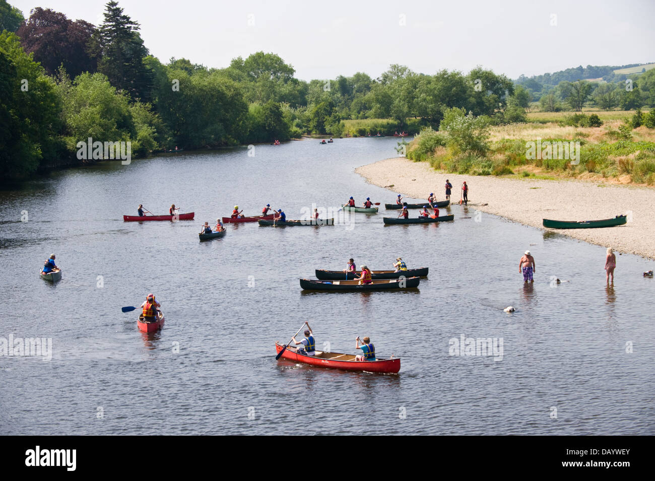 Children & adults in open canoes practice their canoe skills before