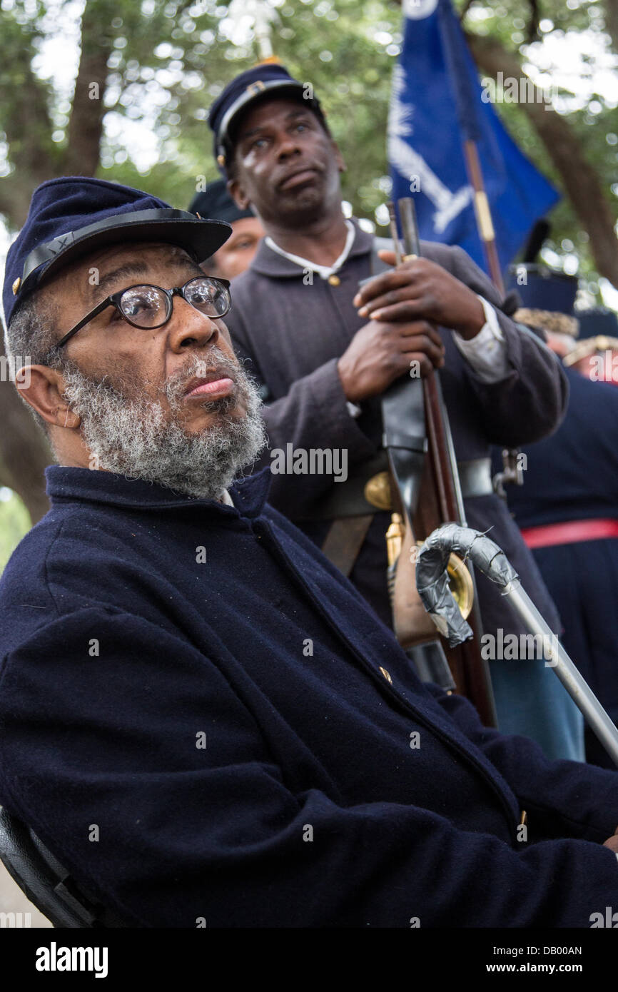 Civil War re-enactors representing the all black 54th Massachusetts Volunteer Infantry listen during a ceremony unveiling a memorial honoring the 54th on the 150th anniversary of the assault on Battery Wagner July 21, 2013 in Charleston, SC. The battle memorialized in the movie 'Glory' took place in Charleston and was the first major battle of an all black regiment. Stock Photo