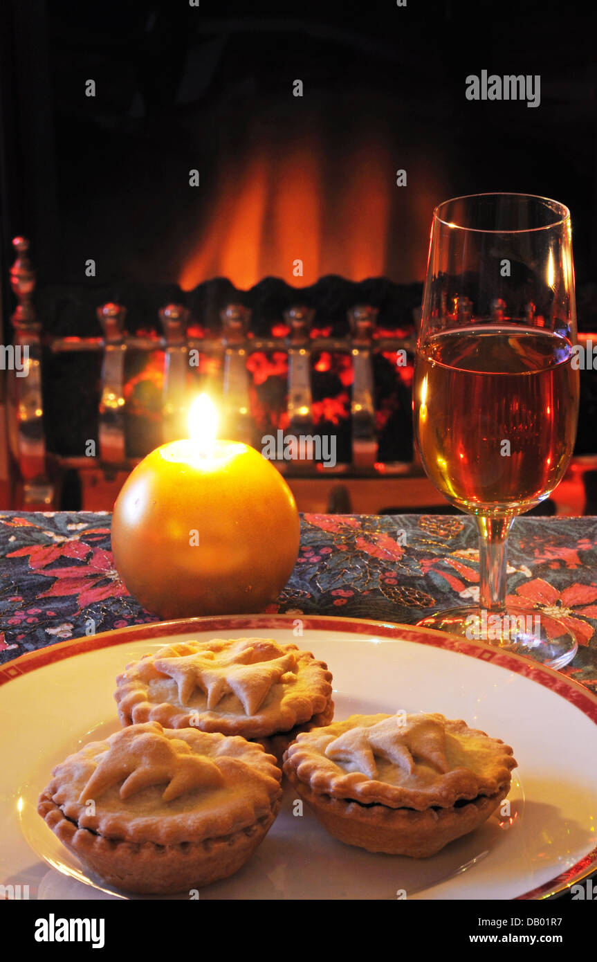 Mince pies and sherry with a candle and fireplace to the rear. Stock Photo