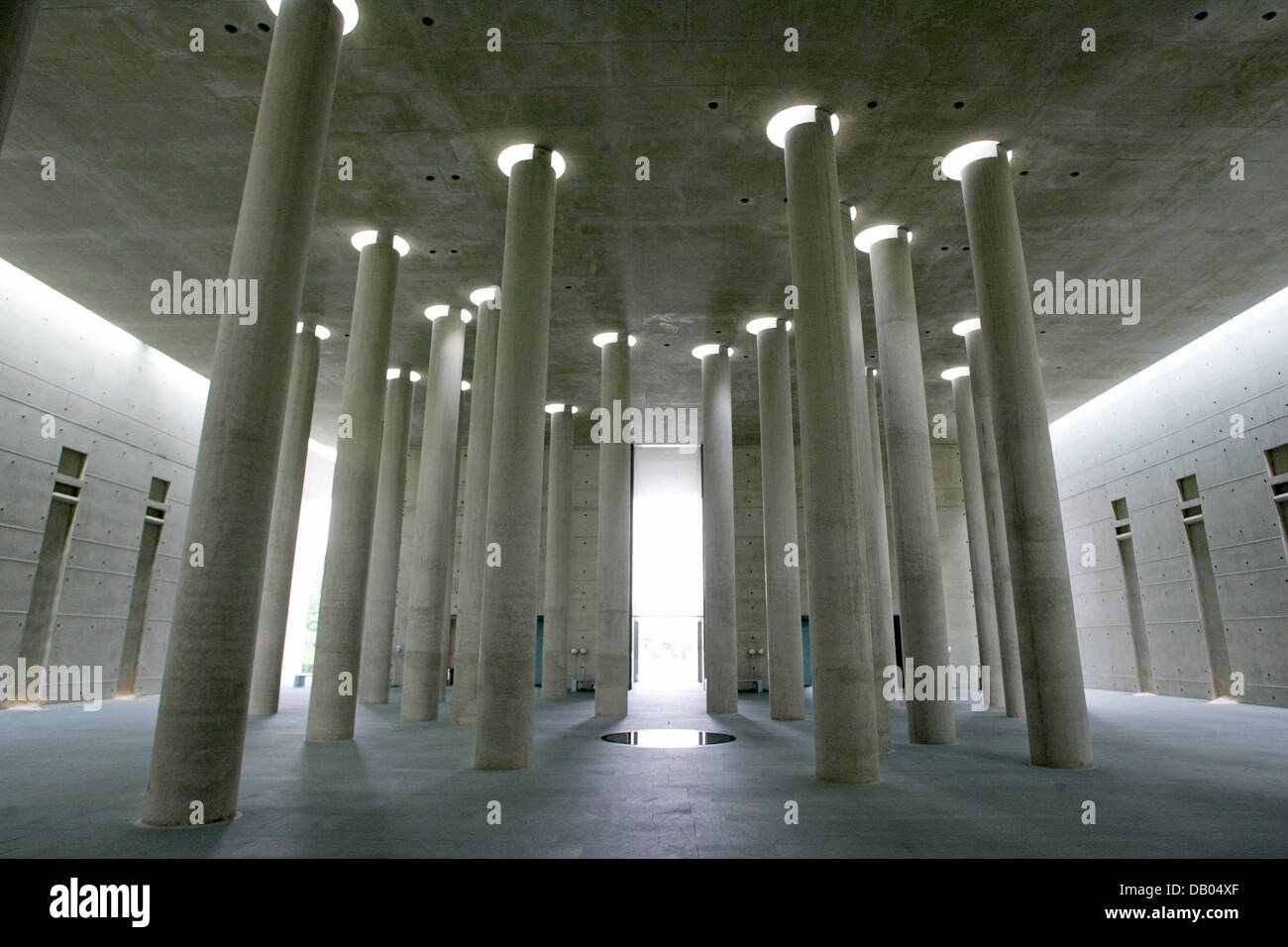 The photo depicts a general view of the inner mourning courtyard with 29 circular columns, just as much circular ceiling openings, and a dark, circular ground plate sculpture at Baumschulenweg crematorium in Berlin Treptow, Berlin, 6 June 2007. Every coffin is labeled with the person's birth and death date, the date of delivery to the crematorium and the undertaker's ident number.  Stock Photo