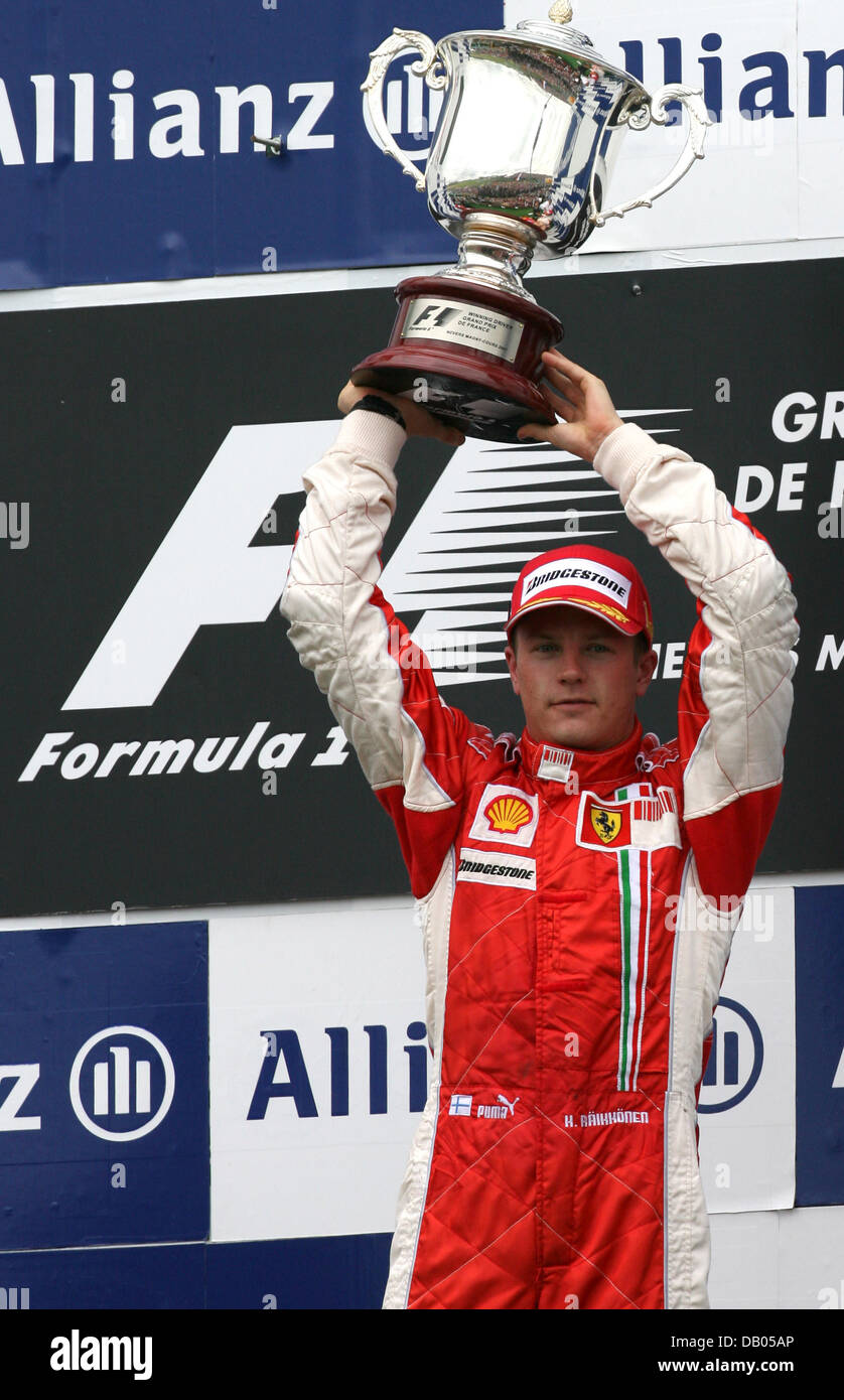 Ferrari's Kimi Raikkonen with the winners trophy on the podium after  winning the British Grand Prix at Silverstone, Northamptonshire Stock Photo  - Alamy