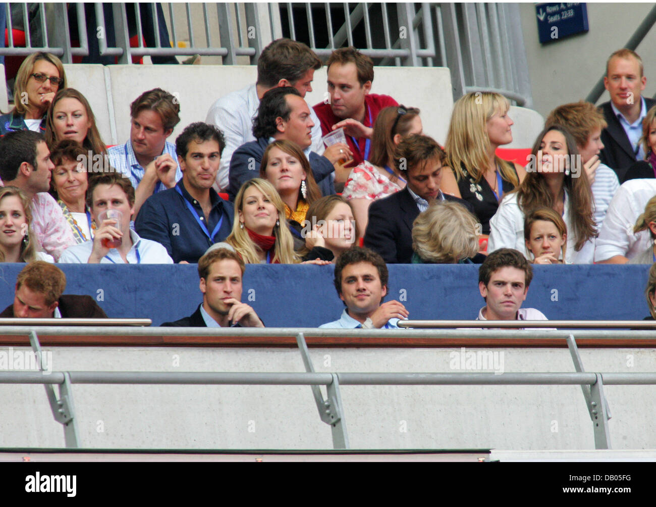 Prince William (2nd R), Prince Harry (2nd L) and his girlfriend Chelsy Davy (L) seen in the crowd at the charity concert in memory of Diana, Princess of Wales on what would have been her 46th birthday at Wembley Stadium, London, 1 July 2007. Photo: Hubert Boesl Stock Photo