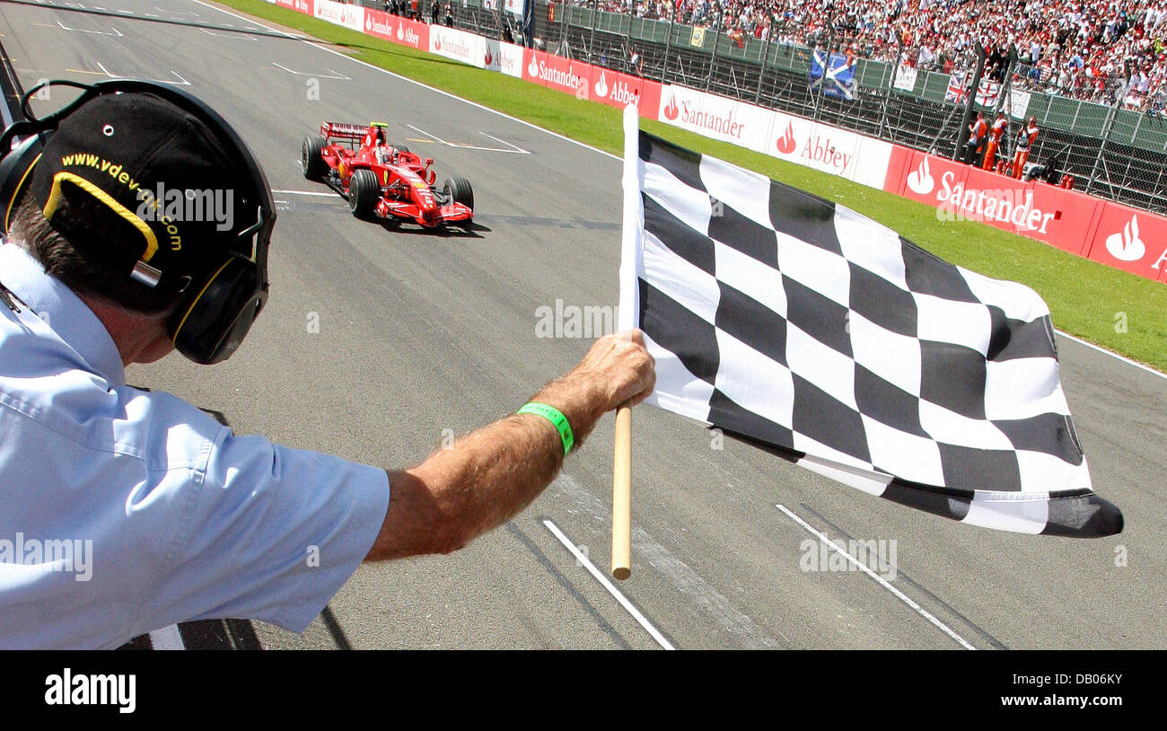 Finnish Formula One Driver Kimi Raikkonen Of Scuderia Ferrari Passes The Chequered Flag As He Wins Finnish Formula One Driver Kimi Raikkonen Of Scuderia Ferrari Passes The Chequered Flag As He Wins