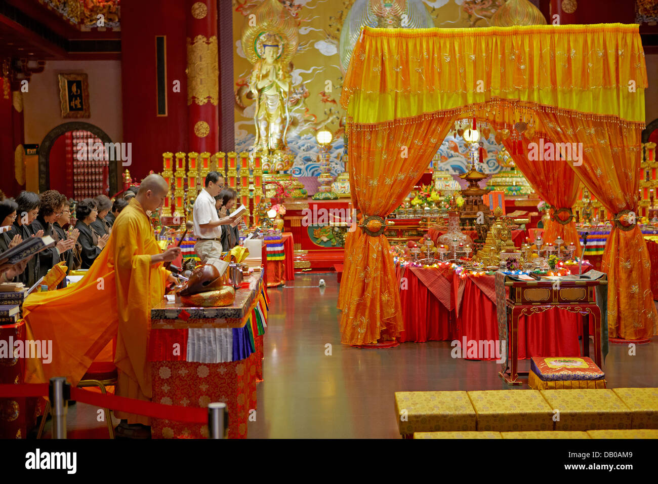 Buddhist ritual ceremony in Buddha Tooth Relic Temple. Chinatown, Singapore. Stock Photo