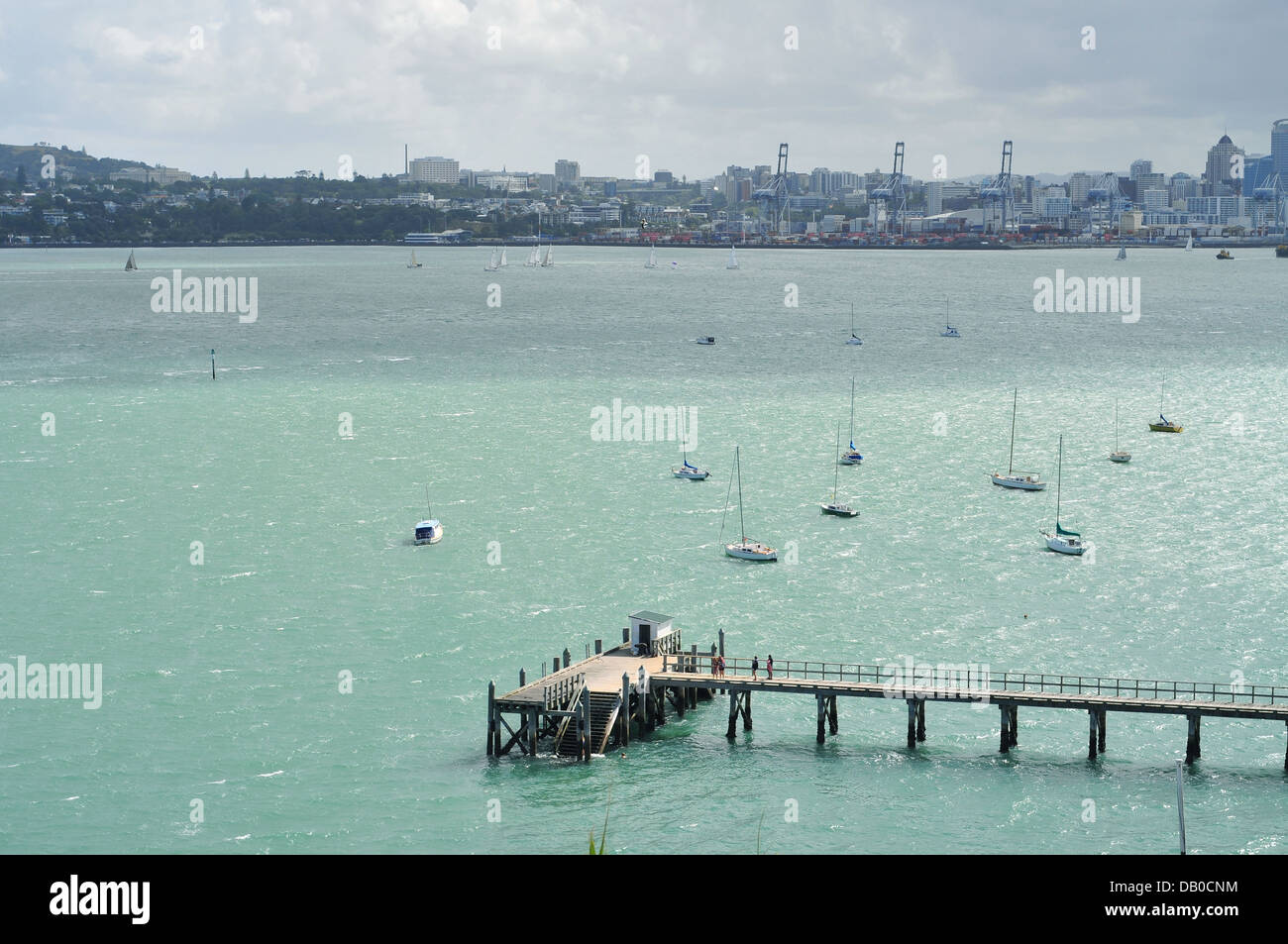 Torpedo Bay wharf view from Devonport North Head with Auckland ports in the distance Stock Photo